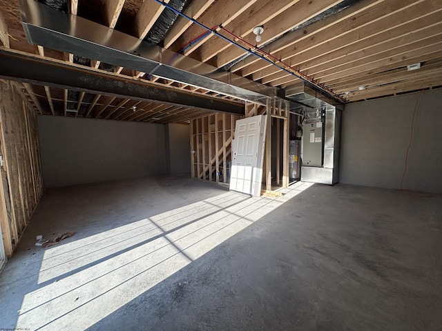 basement featuring heating unit and water heater