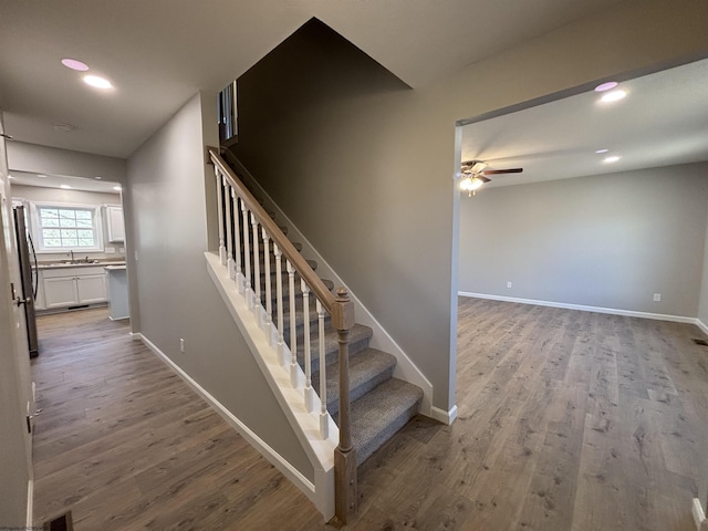 staircase with recessed lighting, baseboards, wood finished floors, and ceiling fan