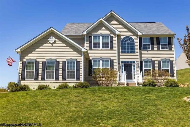 colonial inspired home with a front lawn