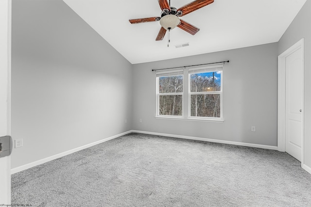 unfurnished room with a ceiling fan, baseboards, visible vents, lofted ceiling, and carpet flooring