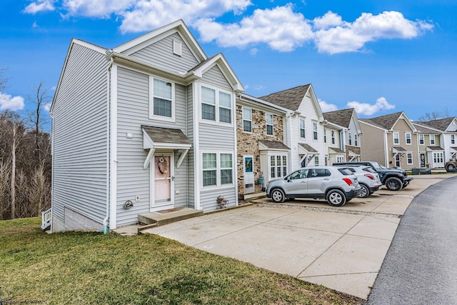 townhome / multi-family property with a residential view and a front lawn