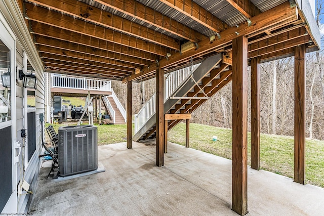 view of patio with central air condition unit and stairway