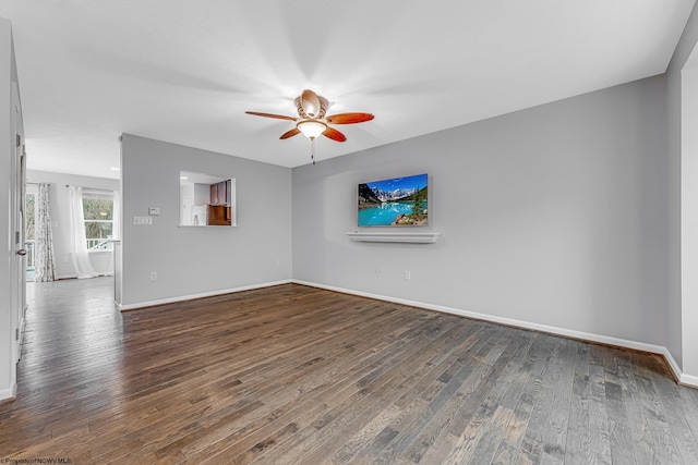 unfurnished living room with baseboards, a ceiling fan, and wood finished floors