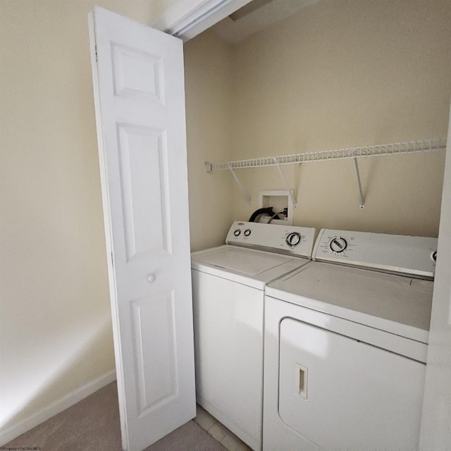 laundry room with laundry area, washing machine and dryer, and baseboards