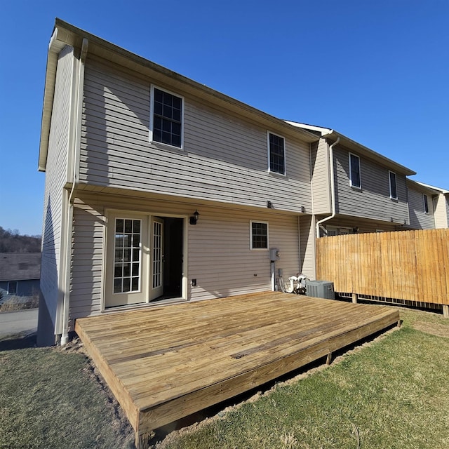 back of house featuring a deck, cooling unit, and fence