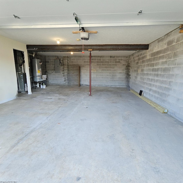 garage featuring gas water heater, concrete block wall, electric panel, and a garage door opener