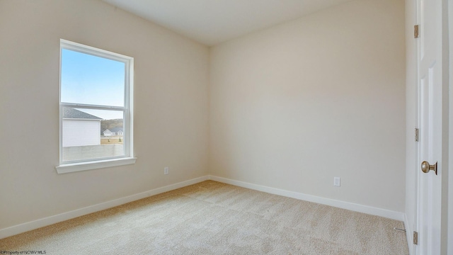 empty room with baseboards and carpet floors