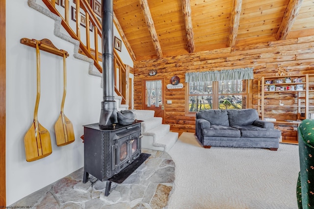 living room featuring log walls, high vaulted ceiling, beam ceiling, a wood stove, and wooden ceiling