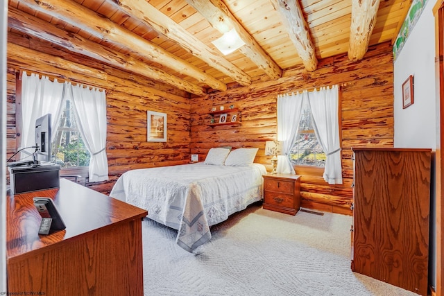 bedroom with beam ceiling, wood ceiling, log walls, and carpet floors