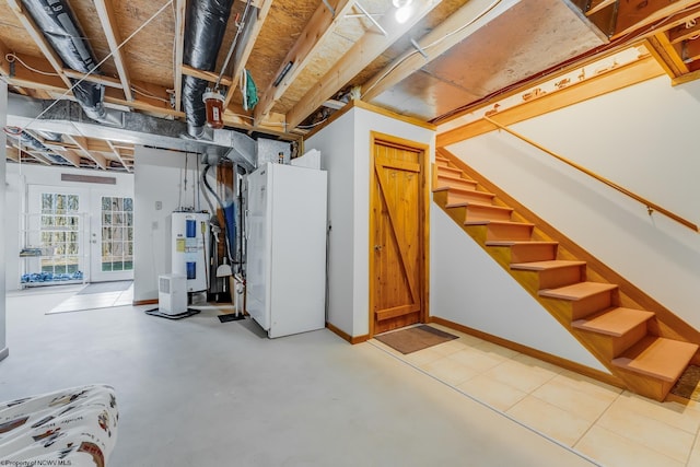 below grade area with stairs, baseboards, and electric water heater