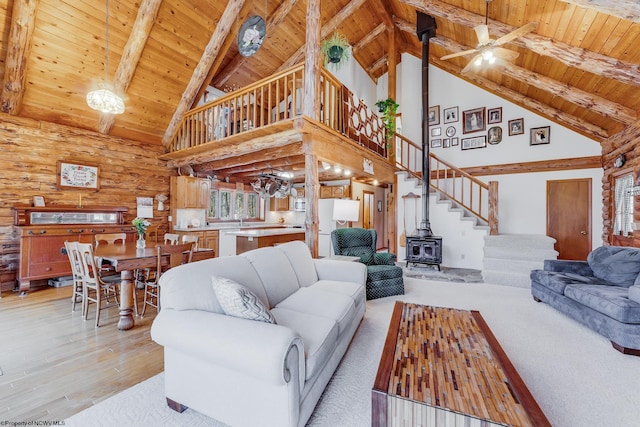 living room with stairs, light wood-type flooring, wood ceiling, and a ceiling fan