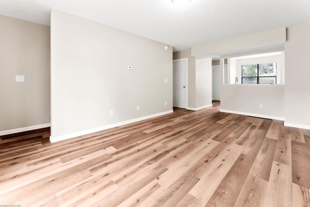 empty room featuring light wood-style floors and baseboards