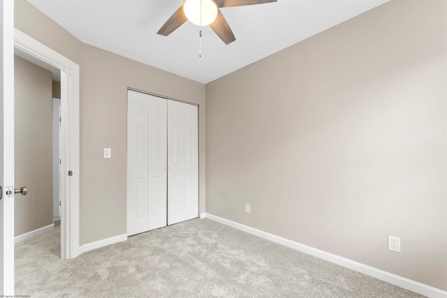 unfurnished bedroom with a ceiling fan, baseboards, a closet, and carpet floors