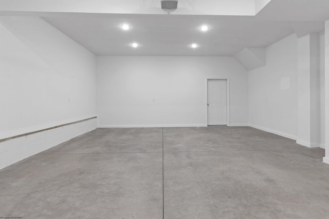 garage with recessed lighting and baseboards