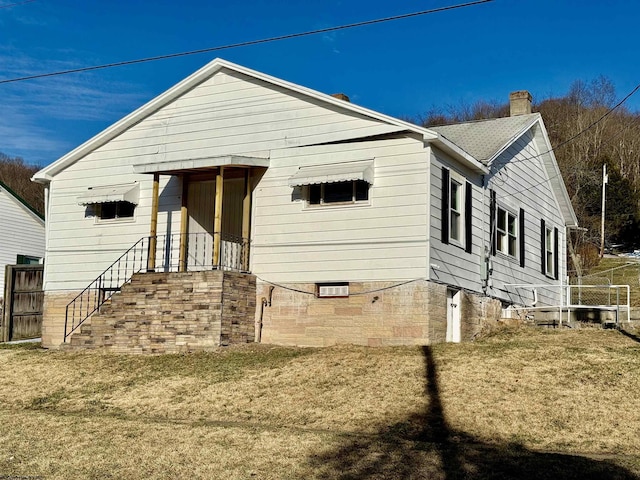 view of front of home with a chimney and fence