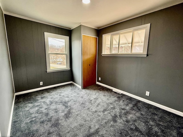 unfurnished bedroom featuring a closet, baseboards, and carpet