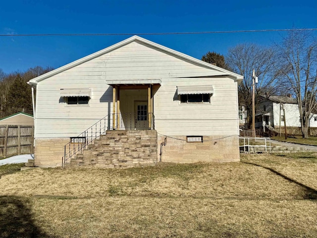 view of front of home with fence and crawl space