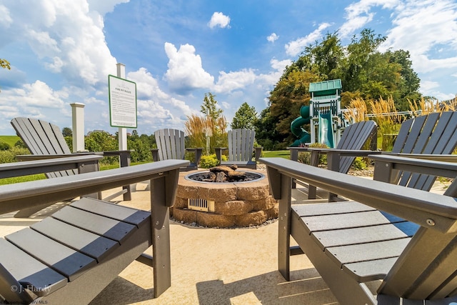 view of patio featuring a playground and a fire pit