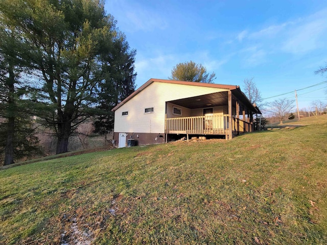 view of side of property with a lawn and a deck