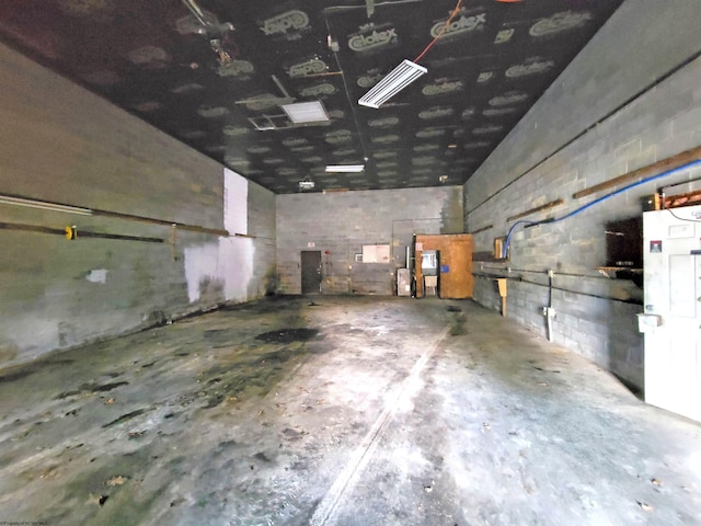 garage with concrete block wall