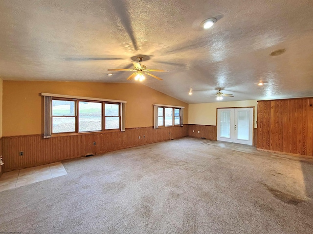 spare room with a wainscoted wall, a textured ceiling, and ceiling fan