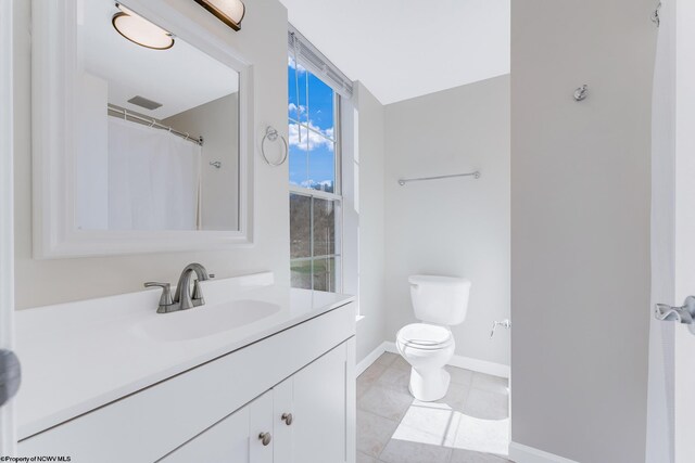 full bathroom with baseboards, toilet, vanity, and tile patterned flooring