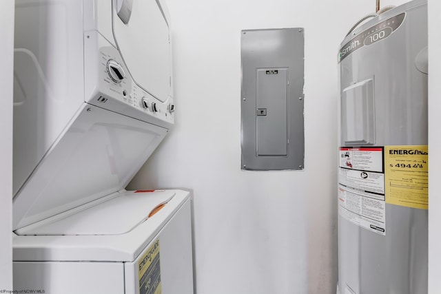 washroom featuring water heater, laundry area, stacked washing maching and dryer, and electric panel