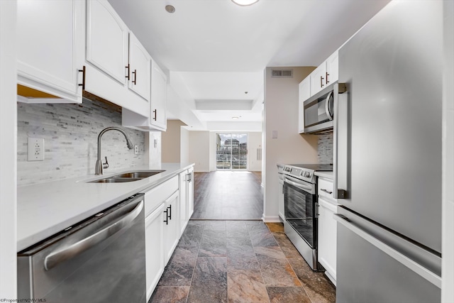 kitchen with visible vents, a sink, light countertops, white cabinets, and appliances with stainless steel finishes