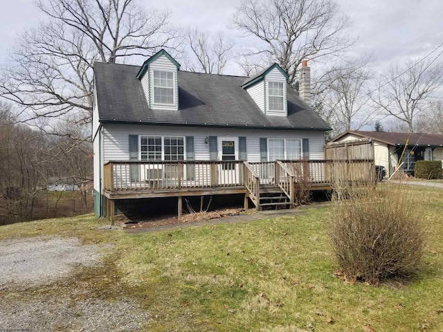 view of front of house with a deck, a front lawn, and a chimney