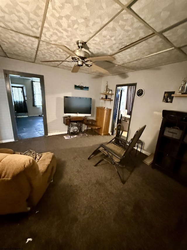living area featuring carpet flooring and ceiling fan
