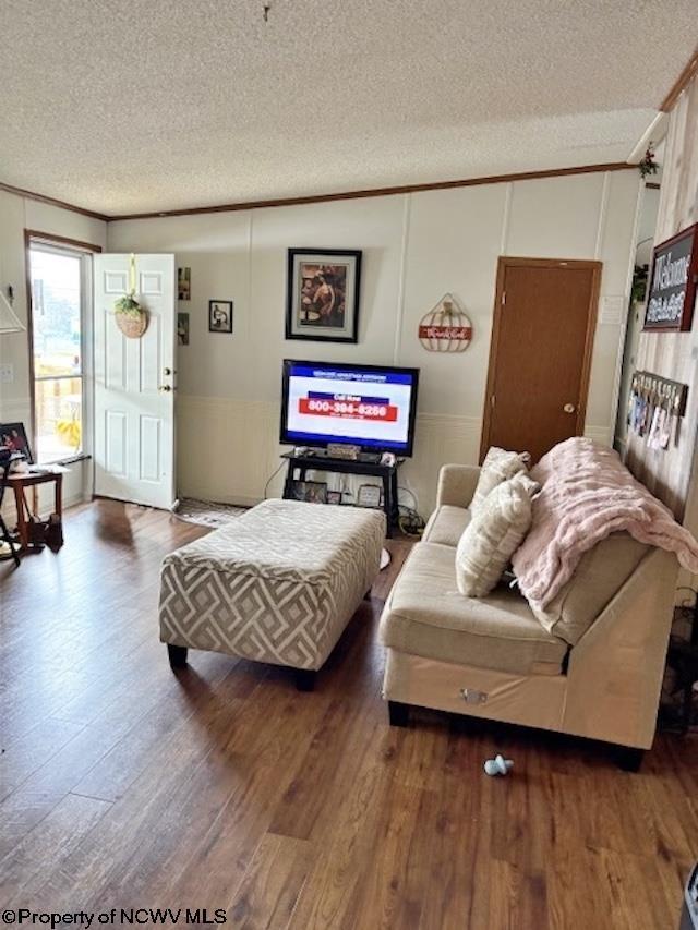 6615 Old Mill Rd, Jane Lew, WV 26378 - living room featuring a textured ceiling, wood finished floors, and ornamental molding