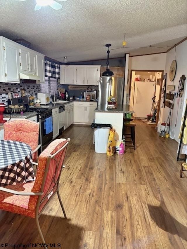 6615 Old Mill Rd, Jane Lew, WV 26378 - kitchen with under cabinet range hood, black gas range, dishwashing machine, white cabinetry, and dark wood-style flooring