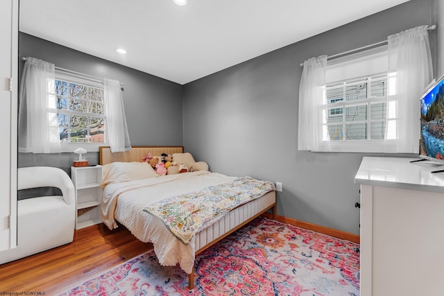bedroom with recessed lighting, baseboards, and wood finished floors