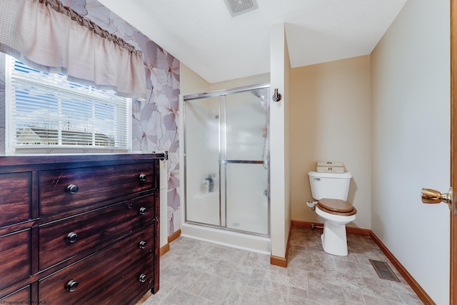 full bathroom with visible vents, a stall shower, toilet, and baseboards