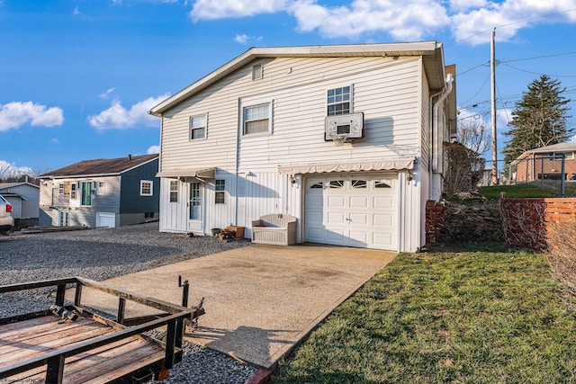 back of property featuring cooling unit, an attached garage, driveway, and a yard
