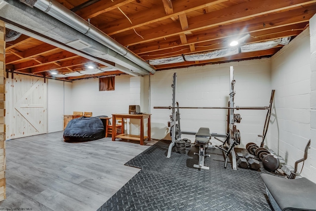 exercise room featuring wood finished floors