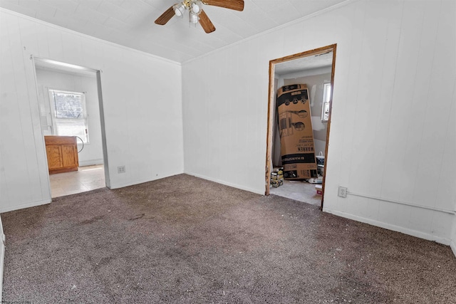 carpeted empty room with crown molding and ceiling fan
