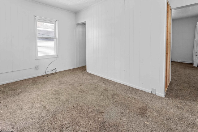 carpeted empty room with ornamental molding and visible vents
