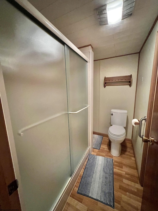 762 Pearl St, Grafton, WV 26354 - bathroom with baseboards, wood finished floors, a stall shower, and toilet