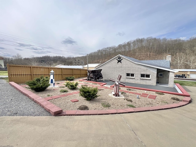 762 Pearl St, Grafton, WV 26354 - view of front of property featuring a patio area, fence, and a chimney