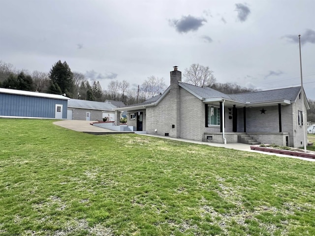 762 Pearl St, Grafton, WV 26354 - back of house with a chimney, brick siding, and a yard