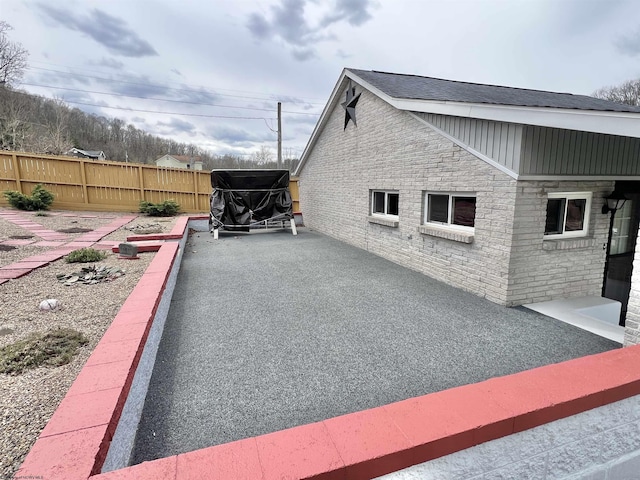 762 Pearl St, Grafton, WV 26354 - view of side of property featuring stone siding, fence, and a patio
