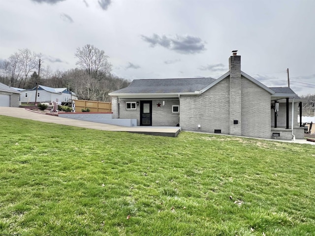 762 Pearl St, Grafton, WV 26354 - back of property featuring a chimney, brick siding, and a yard
