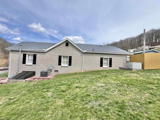 762 Pearl St, Grafton, WV 26354 - back of property featuring cooling unit, brick siding, and a yard