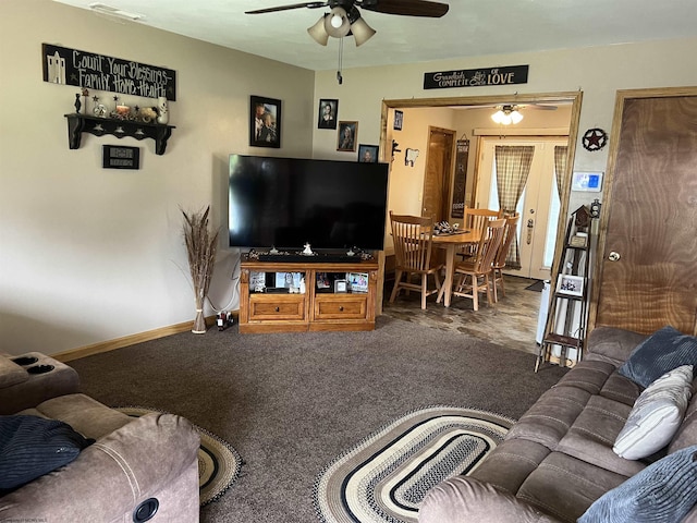 living room featuring baseboards, carpet, and a ceiling fan