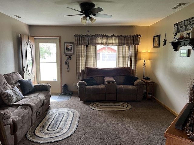 carpeted living room featuring baseboards, ceiling fan, and visible vents