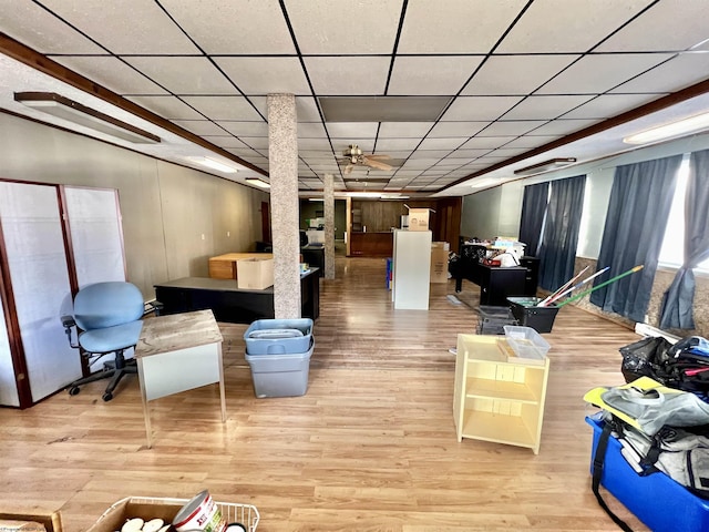 below grade area featuring light wood-style flooring and a paneled ceiling