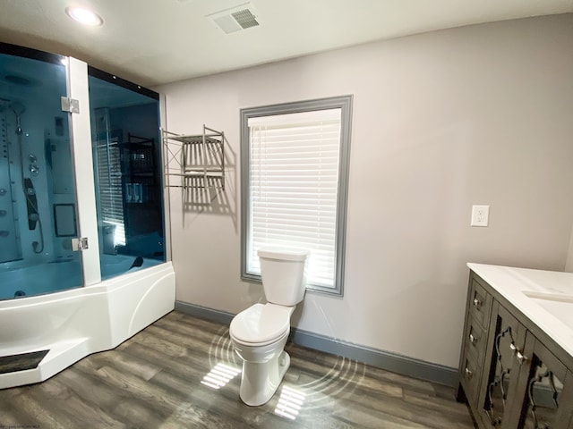 full bath with visible vents, wood finished floors, toilet, and vanity