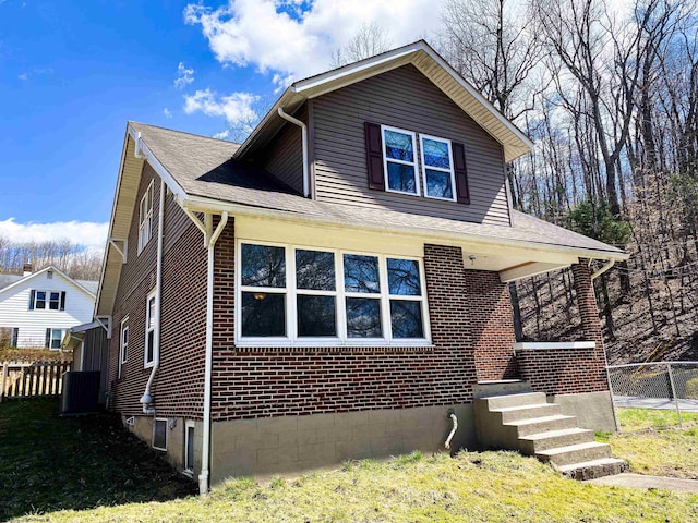 bungalow with brick siding and fence