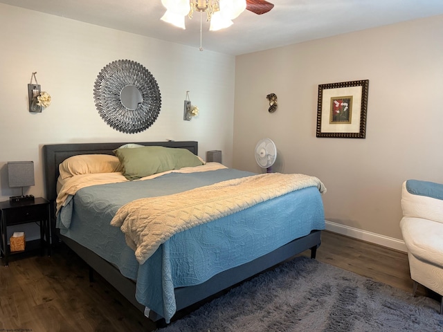 bedroom featuring baseboards, ceiling fan, and wood finished floors